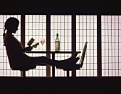 Silhouette of a Woman Reading; Bottle and Glass of Wine