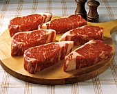 Raw Top Loin Steaks on a Cutting Board