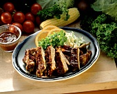 Barbecue Ribs on a Platter with an Orange Slice