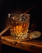 Ein Glas Whiskey on the Rocks; Deko: alte Taschenuhr