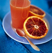 Halved Blood Orange with a Glass of Blood Orange Juice