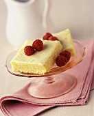 Two Lemon Cake Squares with Frosting and Raspberries
