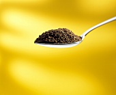 A Spoonful of Ground Coffee; Yellow Background