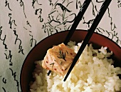 Piece of Salmon in Chopstick; White Rice