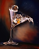 An Ice Cube Falling into a Bent Martini Glass
