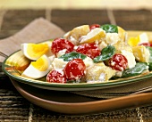 Potato salad with cherry tomatoes, basil and mayonnaise