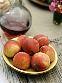 Bowl of Peaches on Wooden Table