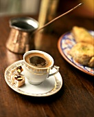 Arabic mocha in cup; mocha pot; pastries