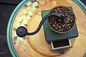Old coffee mill with coffee beans