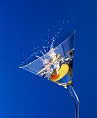 Olive falling into Martini glass