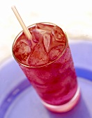 Cranberry juice with ice cubes and straw