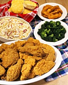 A Platter of Fried Chicken with Coleslaw, Vegetables and Biscuits