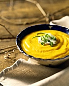 Creamed pumpkin soup with crème fraiche and spring onions