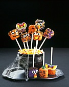 Halloween Face Lollipops in a Bowl of Candy Corns