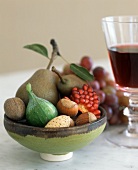 A bowl of fruit and nuts