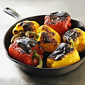 Roasted Whole Red and Yellow Peppers in an Iron Skillet