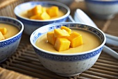 Bowls of Mango Pudding on Tray (Close-up)