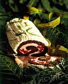A Chocolate Yule Log with Raspberry Filling and White Chocolate Frosting