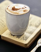 Cup of hot chocolate on book