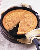 Cornbread in a Cast Iron Skillet with Slice Removed