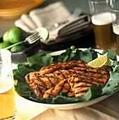 A Platter of Grilled Chicken Breast with Limes