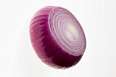 Peeled red onion with a piece cut off