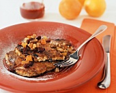 Granola Pancakes Topped with Dried Fruit and Maple Syrup