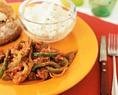 Minute Steak Topped with Stewed Tomato and Peppers with a Side of Garlic Mashed Potato