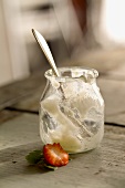 Empty yoghurt jar and remains of a strawberry