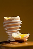 Soft-boiled egg on spoon and in spiral eggcup