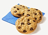 Three Chocolate Chip Cookies on a Blue Napkin
