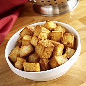 Fried diced potato in white bowl
