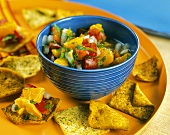 A Bowl of Clementine Salsa with Seasoned Crackers