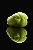 A Chayote Squash on Black with Reflection