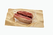 Two Raw NY Strip Steaks on Butcher's Paper