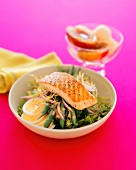 A Grilled Peppered Salmon Fillet over Green Bean Salad