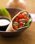 Pita bread filled with meatballs and peppers