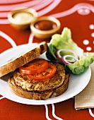 A Tofu Burger on Grilled Sourdough with Tomatoes, Lettuce and Onions