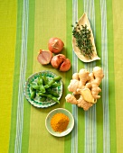 Curry Powder, Ginger Root, Thyme, Shallots and Soy Beans on a Green Striped Cloth
