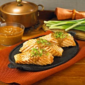 Grilled Salmon on an Oval Griddle with Peanut Sauce and Green Onions