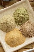 Four different spices (ground) on platter