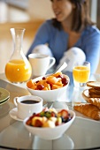 Woman with healthy breakfast of fruit salad & orange juice