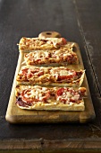 Rectangular Tomato Tarts on a Wooden Board