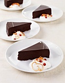 Slices of Decadent Chocolate Tart with Whipped Cream and Pomegranate Seeds