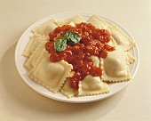 Ravioli on white plate with tomato sauce