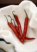 Five red chilis in a white towel