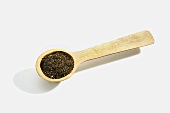 Wooden Spoonful of Celery Seeds on White Background