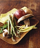 Still life with asparagus, beans, mushroom, onion & garlic