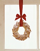 Bread wreath with red bow used as Christmas decoration