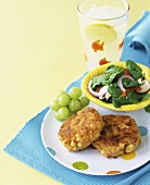 Salmon cakes with grapes and salad